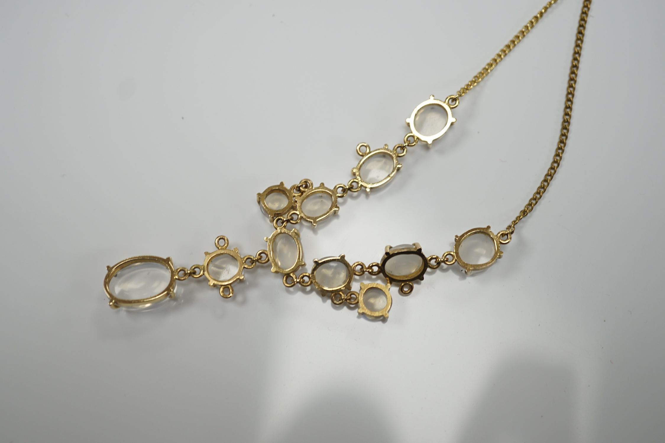 An Edwardian style 9k and cabochon moonstone cluster set drop necklace, 48cm, gross weight 11.2 grams.
